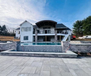 Masonry around an inground pool with gray bricks