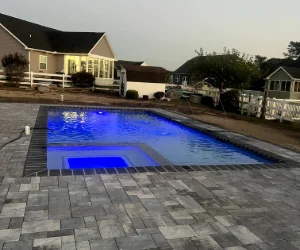 Dark gray stone tiles surrounding an inground pool