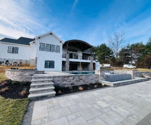 Masonry around an inground pool with gray bricks