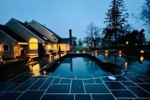 Residential backyard landscape design featuring a pool in Ardmore, PA