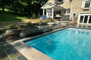 Landscape Design featuring Hardscape and a Backyard Pool in Broomall, PA